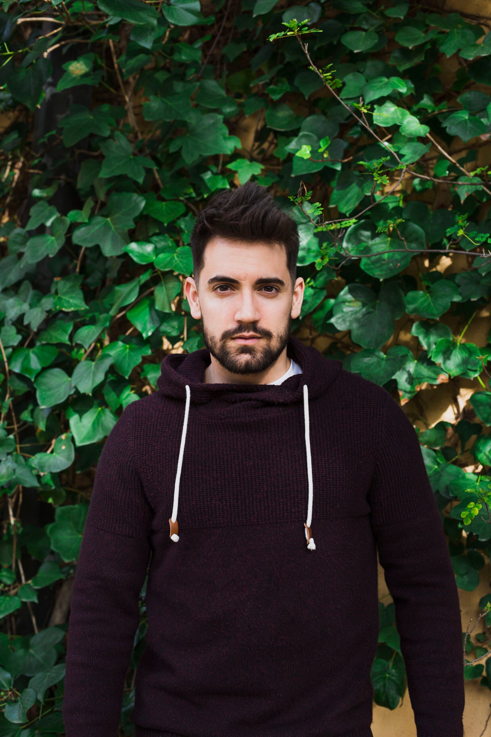 man-standing-near-green-leaves